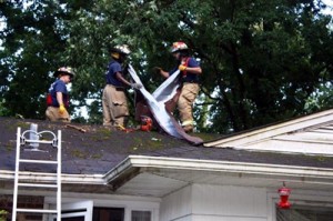 Firefighters Place Tarp on Lasalle Road Home
