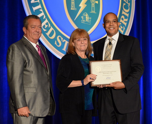 Bonnie C. Carroll, IIa founder and CEO, center, receives the DOE Woman-owned Small Business Award for Fiscal Year 2014 from John Hale III, director of the Office of Small and Disadvantaged Business Utilization for DOE. (Photo courtesy IIa)
