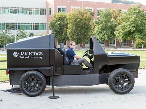 An ORNL researcher powers up the 3D-printed vehicle and building that were part of a nine-month research demonstration project and unveiled on Industry Day at ORNL on Wednesday, Sept. 23, 2015. (Photo by John Huotari/Oak Ridge Today)