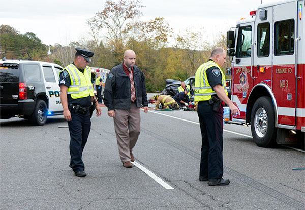 The Oak Ridge Police Department investigates a two-vehicle crash with injuries on Bethel Valley Road between Scarboro Road and South Illinois Avenue on Tuesday, Oct. 27, 2015. Above from left are John Hill, Bill Weaver, and Brad Jenkins. (Photo by John Huotari/Oak Ridge Today)
