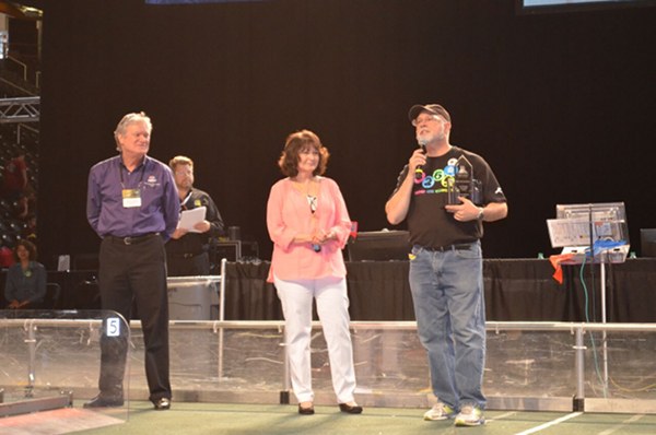 The Secret City Wildbots of Oak Ridge High School are pictured above at the 2016 Smoky Mountain Regionals in Knoxville this week. Team 4265 mentor Mark Buckner, right, was presented with the Volunteer of the Year award. (Photo by Angi Agle)