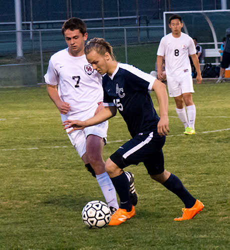Oak Ridge junior midfielder Noah Calhoun (7) is pictured above with Benji Brubaker of Anderson County (15) during a 5-0 win for the Wildcats at home on Thursday, April 14, 2016. (Photo by John Huotari/Oak Ridge Today)