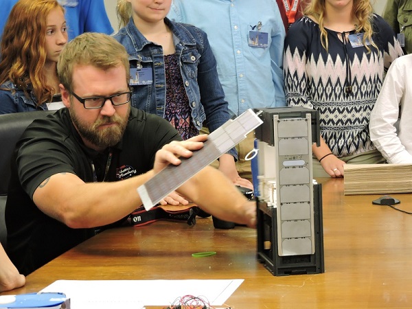 Robertsville Middle School students meet with NASA engineers at the Marshall Space Flight Center in Huntsville, Alabama, on Thursday, May 19, 2016. The small cube satellites that the students created were 1U (1 cube unit). This is an actual 6U (the size of 2x3 of the 1Us) cube satellite that is used to carry payloads in space. (Submitted photo via Oak Ridge Schools)