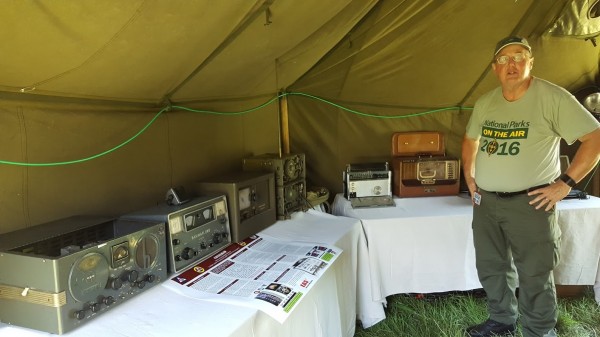 Sterling Edmunds of the Roane County Amateur Radio Club explains historical communication to visitors during the Secret City Festival. In the background are working, restored military “morale” radios and receivers from WWII and the Cold War. (Submitted photo)