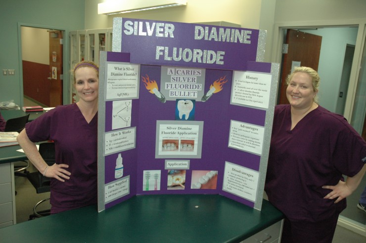 Roane State dental hygiene students Kim Palmer (left) and Crystal Morse won first place at a state competition for their display on silver diamine fluoride. (Photo by RSCC)