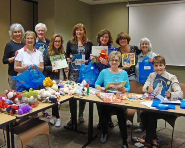Members of Altrusa International of Oak Ridge visited Methodist Medical Center to assemble special activity bags to be distributed to children waiting for loved ones who are patients at Methodist. The women pose with the variety of books and toys they included in each bag. (Submitted photo)