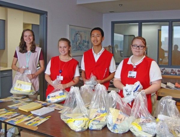 From left, Katie Starnes, Ryann Whitson, Henry Shen, and Katie Law assemble falls-prevention packets used for patient care. They are just a few of the 45 Junior Volunteers who have taken time from their summer vacations to serve at Methodist Medical Center. (Submitted photo)