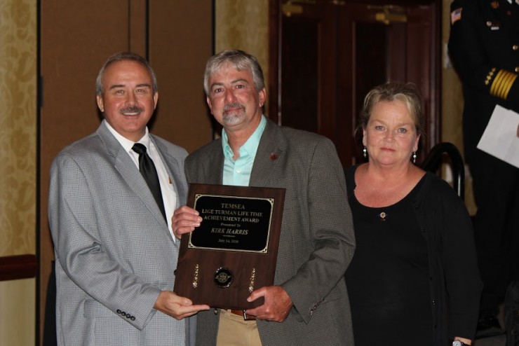 Tennessee EMS Education Association president Tim Lankford presents the Lige Turman Lifetime Achievement Award to Roane State’s Kirk Harris, who is joined by Rebecca Calfee with Roane State Continuing Healthcare Education. (Photo by Roane State Community College)