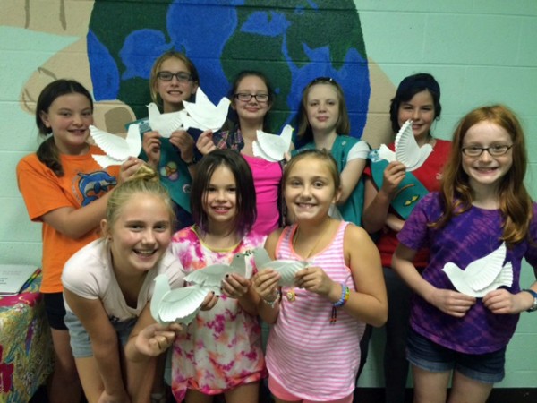 Whole Troop: Cadette Girl Scouts of Troop 20069 created white doves as a symbol of peace. Front row, from left, are Sophie Waraksa, Aiya Davis, and Alyssa Setzer. Back row, from left, are Ashli Allison, Lindsey Fiscor, Bethany Dowdy, Andrea Irene Range, Georgia Gunter, and Bethany Watson. (Submitted photo)