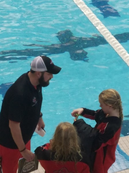 Coach Andy Wagner provides tutelage to Abigail King after an Atomic City Aquatic Club record swim. (Submitted photo)