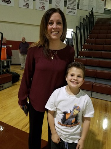 AJ Cucksey meets Oak Ridge Lady Wildcats Coach Paige Redman during a Region 2-AAA quarterfinal game at Wildcat Arena in February 2017. (Photo courtesy Prayers for AJ)