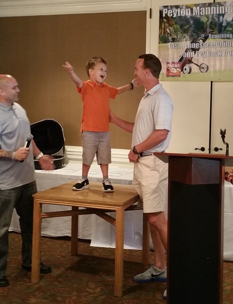 AJ Cucksey sings "Rocky Top" to retired NFL quarterback and former Tennessee Volunteer Peyton Manning in June 2015. (Photo courtesy Shannon Cucksey)