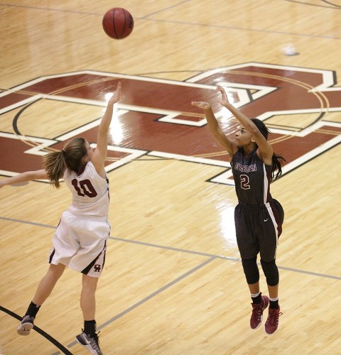 Bearden junior Trinity Lee (2) shoots from three-point range while defended by Oak Ridge senior Courtney Ellison (10) during a 62-56 win for the Lady Wildcats in a Region 2-AAA quarterfinal elimination game at Wildcat Arena on Friday, Feb. 24, 2017. (Photo by Luther Simmons)
