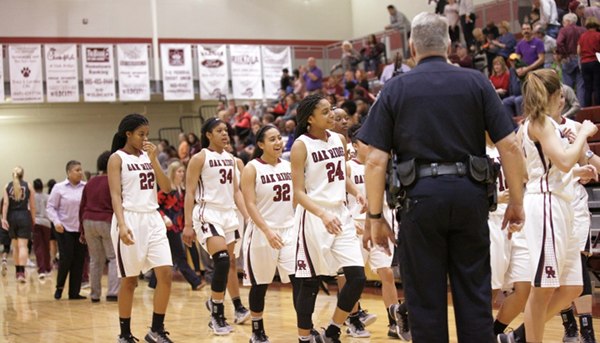 The Oak Ridge Lady Wildcats celebrate after a 62-56 win over Bearden in a Region 2-AAA quarterfinal elimination game at Wildcat Arena on Friday, Feb. 24, 2017. (Photo by Luther Simmons)