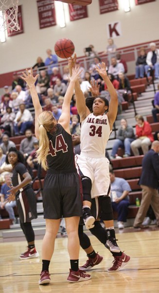 Oak Ridge junior Mykia Dowdell (34) shoots over Bearden junior Grace van Rij (44) during a 62-56 win over Bearden in a Region 2-AAA quarterfinal elimination game at Wildcat Arena on Friday, Feb. 24, 2017. (Photo by Luther Simmons)