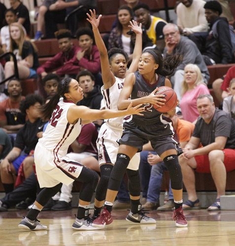 Oak Ridge juniors Jaymi Golden (32), left, and Desiree Bates (20), center, play defense against Bearden junior Trinity Lee (2), who led the Lady Bulldogs with 25 points, in a 62-56 loss to the Lady Wildcats in a Region 2-AAA quarterfinal game at Wildcat Arena on Friday, Feb. 24, 2017. (Photo by Luther Simmons)