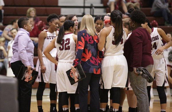 The Oak Ridge Lady Wildcats huddle with Coach Paige Redman during a 62-56 win over Bearden in a Region 2-AAA quarterfinal elimination game at Wildcat Arena on Friday, Feb. 24, 2017. (Photo by Luther Simmons)