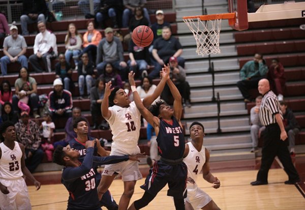 Oak Ridge Wildcats, including junior Levert Smith (10), battle West for the basketball during a 68-38 Region 2-AAA quarterfinal win for the Wildcats at home on Saturday, Feb. 25, 2017. (Photo by Luther Simmons)