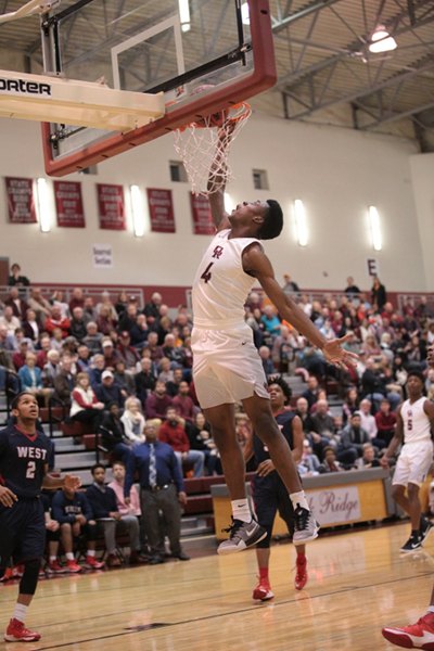 Oak Ridge senior Tyshawn Young (4) goes up for a dunk during a 68-38 Region 2-AAA quarterfinal win against West at home on Saturday, Feb. 25, 2017. (Photo by Luther Simmons)