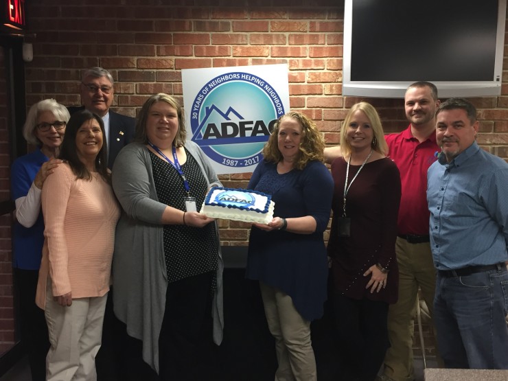 ADFAC Board Member, Cande Seay (left), presenting a 30th Birthday cake to the ORUD employees including (L-R) Polli Wright, Ben Andrews, Emily Rios, Raeshell Maples, Sasha Benjamin, David Bunch and Jeff Patterson.