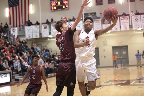 Oak Ridge sophomore Herbert Booker (14) shoots the basketball against Bearden sophomore Drew Pember (3) during an 86-73 win for the Wildcats in the Region 2-AAA basketball championship at Wildcat Arena on Thursday, March 2, 2017. (Photo by Luther Simmons)