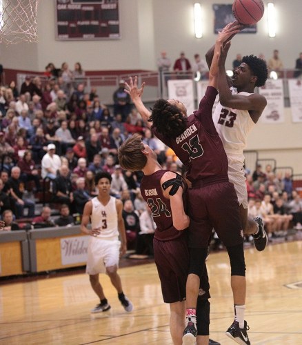 Oak Ridge senior Anthony Gibson (23) was named most valuable player of the 2017 Region 2-AAA tournament. Oak Ridge beat Bearden 86-73 in the Region 2-AAA championship at Wildcat Arena on Thursday, March 2, 2017. Gibson is defended here by Bearden sophomore Roman Robinson (13). (Photo by Luther Simmons)