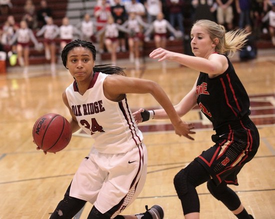 The Oak Ridge Lady Wildcats were led by sophomore Jada Guinn (24) with a game-high 18 points in a 61-44 win over Daniel Boone during a Class AAA sectional at Wildcat Arena on Saturday, March 4, 2017. Guinn is defended here by Daniel Boone senior guard Makenzy Bennett (2). (Photo by Luther Simmons)