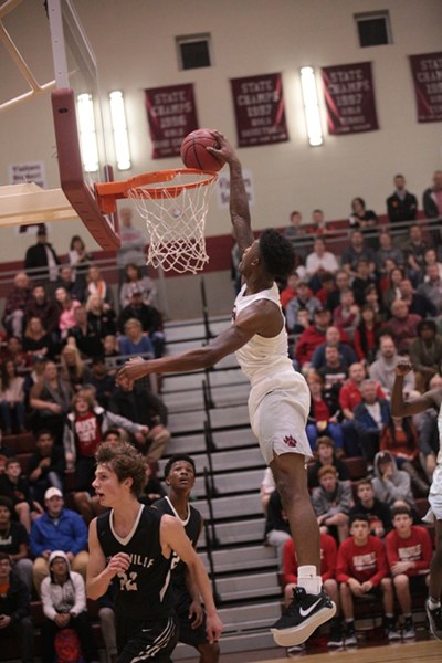 Oak Ridge senior Tee Higgins (5) dunks during a 46-43 win over Maryville in a Region 2-AAA semifinal elimination game at Wildcat Arena on Tuesday, Feb. 28, 2017. (Photo by Luther Simmons)