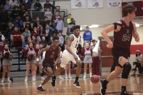 Oak Ridge senior Tee Higgins (5) dribbles the basketball in transition during an 86-73 win over Bearden in the Region 2-AAA basketball championship at Wildcat Arena on Thursday, March 2, 2017. Next to Higgins is Bearden sophomore Trent Stephney (4). (Photo by Luther Simmons)
