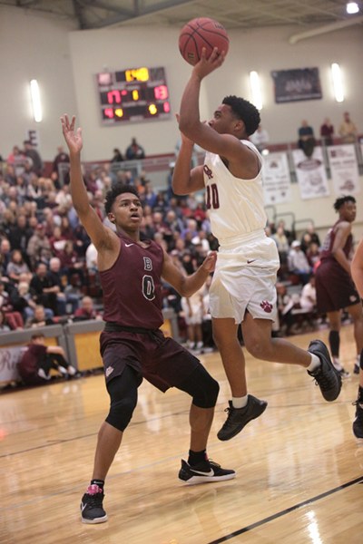 Oak Ridge junior Levert Smith (10) shoots against Bearden sophomore Ques Glover (0) during an 86-73 win for the Wildcats in the Region 2-AAA basketball championship at Wildcat Arena on Thursday, March 2, 2017. (Photo by Luther Simmons)