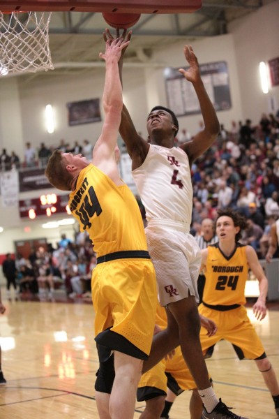 Oak Ridge senior Tyshawn Young (4) shoots against Paul Arrowood (44) of David Crockett during a 90-60 win for the Wildcats in a Class AAA sectional at Wildcat Arena on Monday, March 6, 2017. (Photo by Luther Simmons)