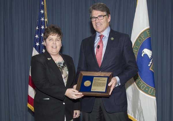 Energy Secretary Rick Perry, right, presents Wendy Cain, left, with DOE’s Federal Project Director of the Year award for 2016. He also presented the Oak Ridge K-31 Facility demolition team with the Department's Achievement Award. The employees received the awards at the 2017 DOE Project Management Workshop in Washington, D.C., on March 22. (Photo by DOE)