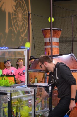 Members of the Secret City Wildbots Team 4265 Drive Team look on as the robot scores high goals with the â€œfuelâ€ (wiffle balls) picked up from the field at the First Robotics Palmetto Regional in Myrtle Beach, South Carolina, on Friday, March 3, 2017. One point is scored for each ball in the high goal. (Photo by Angi Agle)