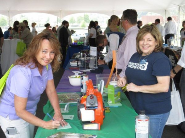 Ann Bratton, co-owner of Downtown Hardware, helps an attendee register for a door prize at last spring's Primetime Fiesta. This year's event will take place on Thursday, April 27, 2017, and it will feature the announcement about the performers at Celebrate Oak Ridge (Secret City Festival). (Submitted photo)