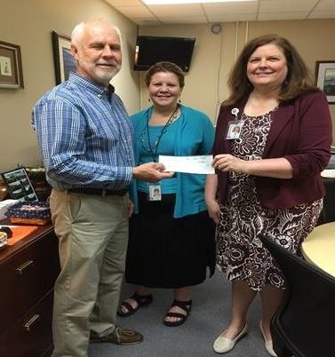 Anderson County Commissioner Myron Iwanski presents a check to Melissa Blalock, Woodland Elementary School assistant principal, and Nancy West, principal. (Submitted photo)