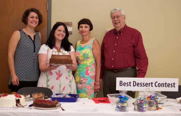 Jeanne Gorman, chocolate contest judge, holds her prize-winning cake from last year's contest. With her are last year's judges, from left, Naomi Asher, Melanie Fillauer, and Tom Beehan. (Submitted photo)