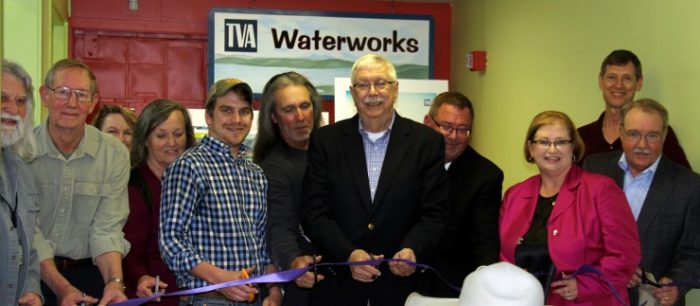 Suzan Bowman, third from right, joins Childrenâ€™s Museum board and staff, members of Carpenters Local 40, and TVA employees and retirees to cut the ribbon for the renovated TVA Waterworks exhibit. (Submitted photo)