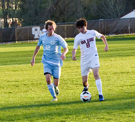 John Belbeck (8) of Oak Ridge tries to keep the soccer ball away from Casey Roberts (12) of Gibbs during a 5-0 win for the Wildcats at the Oak Ridge Soccer Complex on Tuesday, April 4, 2017. (Photo by John Huotari/Oak Ridge Today)