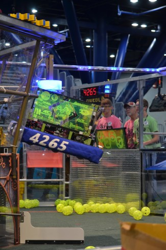 The Secret City Wildbots Team 4265's robot, Luna, successfully climbs at the end of the second qualifying match of the day at the First Robotics Championship in Houston on Thursday, April 20, 2017, with the drive team in background. (Photo by Angi Agle)