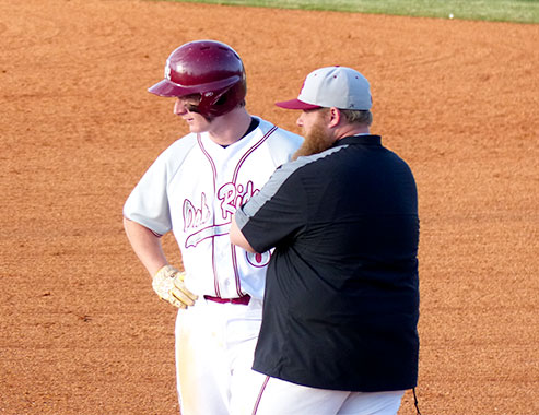 At first base, Oak Ridge senior Brice Mlekodaj (6) talks to assistant coach Kevin Lee during a 9-4 win over Campbell County at Bobby Hopkins Field on Tuesday, April 4, 2017. (Photo by John Huotari/Oak Ridge Today)