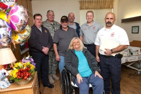 The Y-12 Fire Department paramedics and security police officer who gave Freida Williford, front, lifesaving CPR visited her and her husband at the Harriman Care and Rehabilitation Center. From left behind her are, Justin Blackstock, Joe Perian, Keith Williford, Rick Dettmering, Brad Holt, and Loyd Williams. (Photo by Y-12)