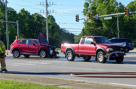 South Illinois Avenue remained closed early Friday afternoon, May 26, 2017, after about 100 gallons of diesel fuel spilled onto the road following a crash involving a dump truck and two vehicles at Lafayette Drive/Scarboro Road in south Oak Ridge. (Photo by John Huotari/Oak Ridge Today)