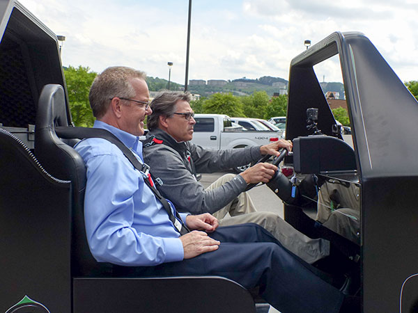 Energy Secretary Rick Perry drives a 3D printed personal utility vehicle at Oak Ridge National Laboratory's Manufacturing Demonstration Facility on Hardin Valley Road on Monday, May 22, 2017. His passenger is Craig Blue, director of energy efficiency and renewable energy programs at ORNL. (Photo by John Huotari/Oak Ridge Today)
