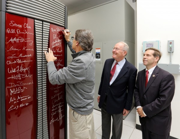 Energy Secretary Rick Perry signs a supercomputer at the Oak Ridge Leadership Computing Facility at Oak Ridge National Laboratory on Monday, May 22, 2017. Also pictured are U.S. Sen. Lamar Alexander, center, and U.S. Rep. Chuck Fleischmann, both Tennessee Republicans. (Photo courtesy Sen. Alexander's office via ORNL)