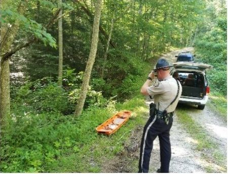 The Laurel County Sheriff's Office in Kentucky is investigating the death of an Oak Ridge woman, Tearsha Laws, 28, who was found in a wooded area over an embankment on Monday evening, June 26, 2017. Pictured above photographing the scene is Deputy Travis Napier. (Photo by Laurel County Sheriff's Office)