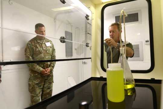 Scientist Glenn Pfennigwerth of Y-12 National Security Complex, right, explains chemical processes used in the Mobile Uranium Facility to Brig. Gen. William E. King IV, commander of the 20th CBRNE Command. (Photo by NNSA)