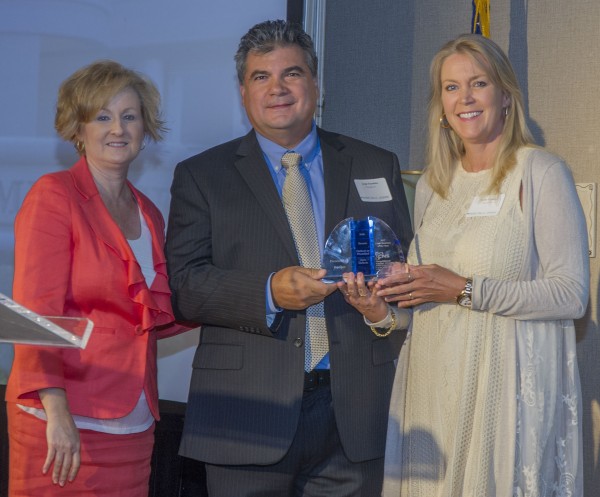Jorge and Deana Sanabria, owners of Expoquip Inc., accept the CNS Small Business of the Year award from Y-12 Socioeconomic Program Manager Lisa Copeland, left. (Photo courtesy CNS)