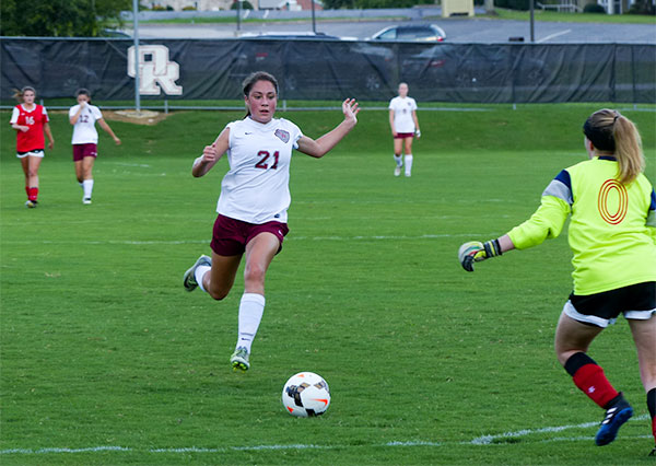 Oak Ridge sophomore Maddie Peters (21) is pictured above during a 8-0 win over Halls at home on Thursday, Aug. 17, 2017. Also pictured is Halls goalkeeper Madison Wright (0). (Photo by John Huotari/Oak Ridge Today)