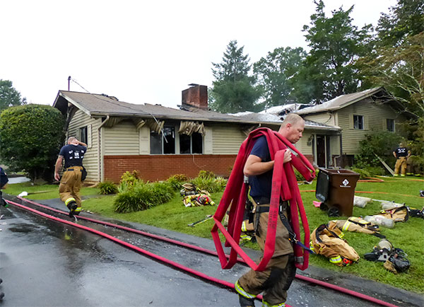 A woman escaped and pets were evacuated after lightning struck a home on Albion Road in east Oak Ridge on Tuesday morning, Sept. 5, 2017, likely destroying the residence, authorities said. Above, the Oak Ridge Fire Department cleans and packs up gear after the fire. (Photo by John Huotari/Oak Ridge Today)