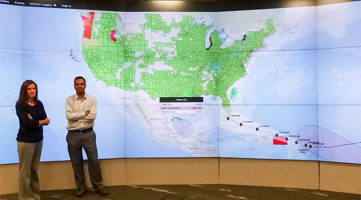 Jibonananda "Jibo" Sanyal, right, and Amy Rose of Oak Ridge National Laboratory discuss the lab's help with data on electric power outages and population counts in hazards and emergencies such as Hurricane Harvey in Texas and Hurricane Irma, approaching from the Atlantic Ocean above, as pictured on Tuesday, Sept. 5, 2017. The map above shows ORNL's EAGLE-I system, and it includes information on the remaining power outage in Harris County, Texas. (Photo by John Huotari/Oak Ridge Today)